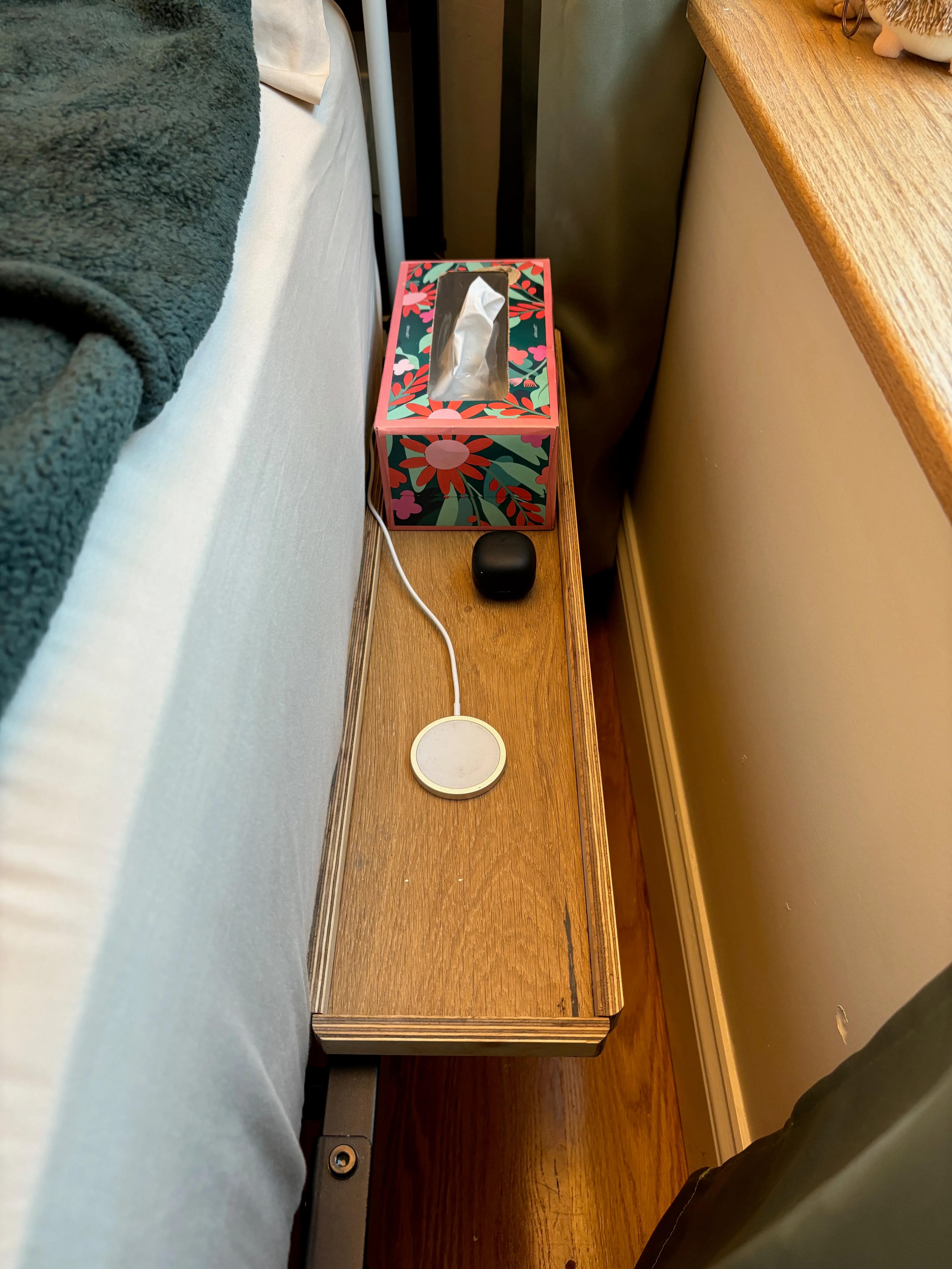 The completed bedside table installed on the bed frame.