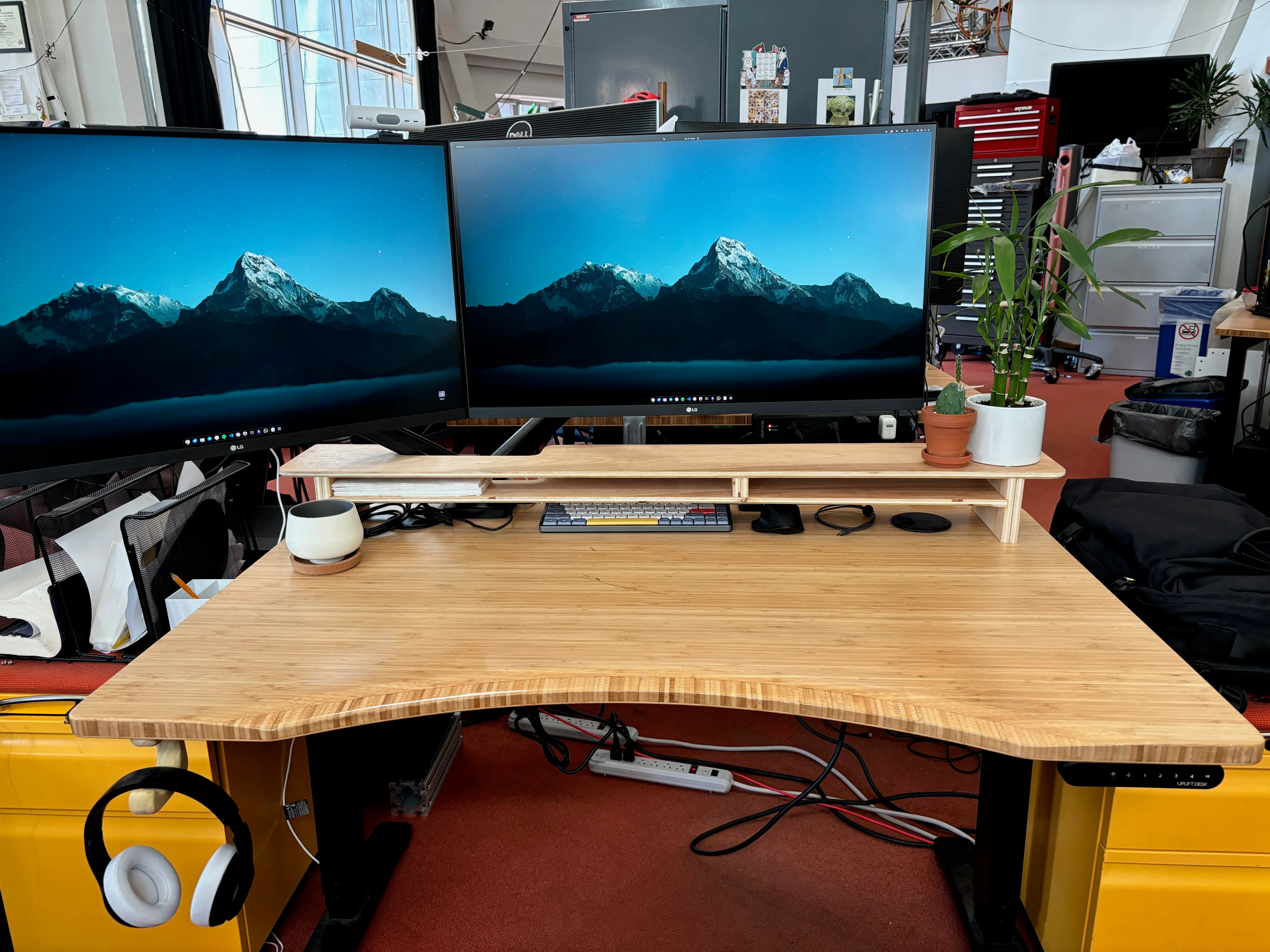 Desk on desk shelf with headphone hook on the bottom of the shelf