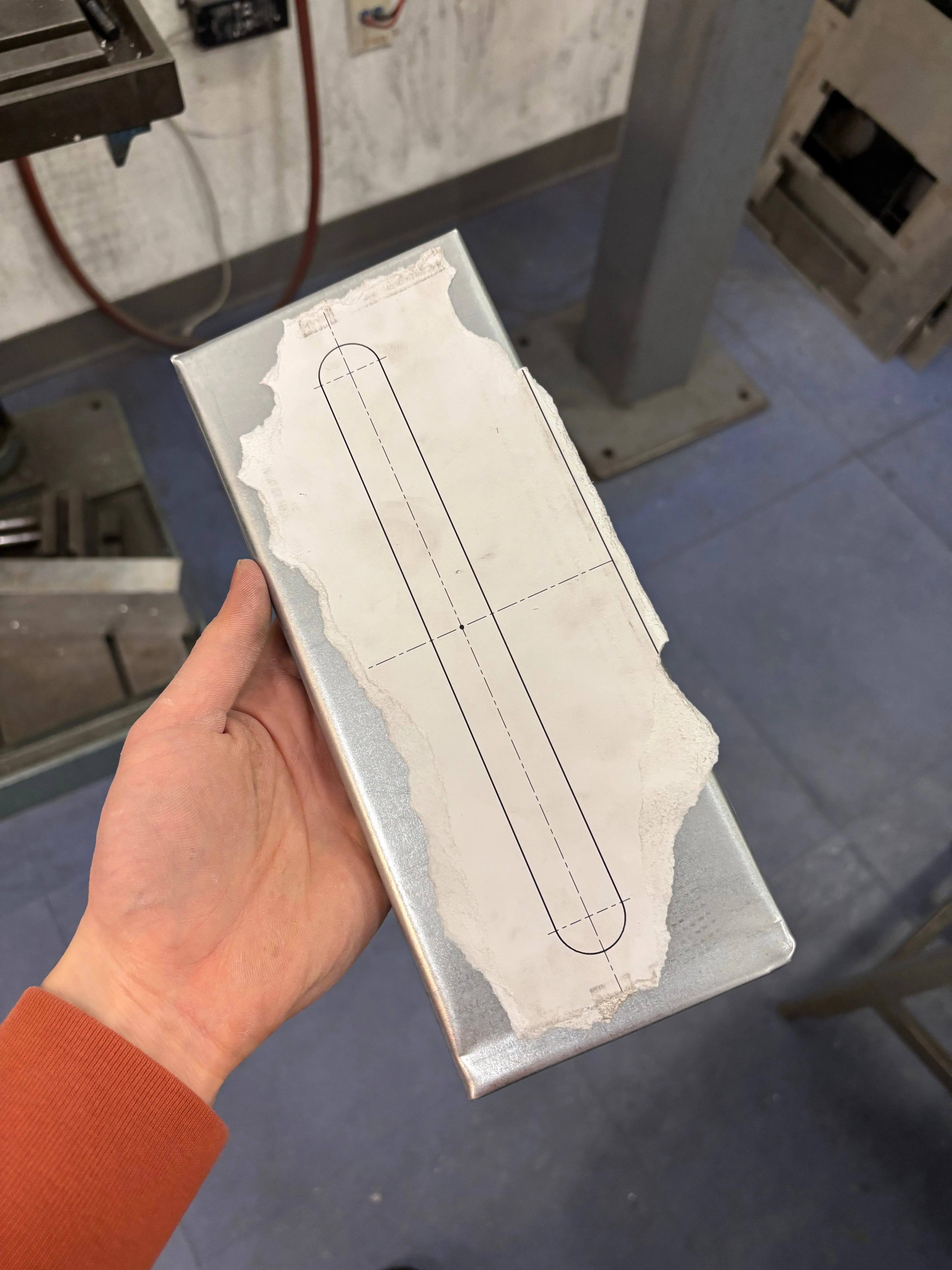 Front of fully folded sheet metal top piece with paper template